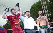 4 August 2023; Kieran Molloy, left, celebrates defeating Sam O'Maison in the first round of their welterweight bout during the Féile Fight Night at Falls Park in Belfast. Photo by Ramsey Cardy/Sportsfile