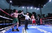 4 August 2023; Fearghus Quinn is declared victorious over Ramiro Blanco in their middleweight bout during the Féile Fight Night at Falls Park in Belfast. Photo by Ramsey Cardy/Sportsfile