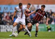 4 August 2023; Dayle Rooney of Drogheda United in action against Bohemians players Bartlomiej Kukulowwicz, left, and James McManus during the SSE Airtricity Men's Premier Division match between Bohemians and Drogheda United at Dalymount Park in Dublin. Photo by Seb Daly/Sportsfile