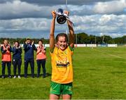 5 August 2023; Donegal captain Niamh Harkin lifts the cup after her side's victory in the ZuCar All-Ireland Ladies Football U18 C final match between Donegal and Waterford at Kinnegad in Westmeath. Photo by Piaras Ó Mídheach/Sportsfile