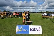 5 August 2023; Donegal captain Niamh Harkin receives the trophy from Trina Murray, Leinster LGFA President and LGFA Vice-President, following the ZuCar All-Ireland Ladies Football U18 C final match between Donegal and Waterford at Kinnegad in Westmeath. Photo by Piaras Ó Mídheach/Sportsfile