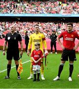 6 August 2023; Manchester United mascot Finn O'Shea, age 9, from Clonmel, Tipperary lines up with Tom Heaton of Manchester United before the pre-season friendly match between Manchester United and Athletic Bilbao at the Aviva Stadium in Dublin. Photo by David Fitzgerald/Sportsfile