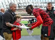 6 August 2023; Manchester United mascot Finn O'Shea, age 9, from Clonmel, Tipperary shakes hands with Aaron Wan-Bissaka of Manchester United before the pre-season friendly match between Manchester United and Athletic Bilbao at the Aviva Stadium in Dublin. Photo by David Fitzgerald/Sportsfile
