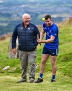 7 August 2023; Poc Fada official Christy Ryan, left, looks on while Tadhg Haran of Galway, competing in the Senior Hurling event during the 2023 M. Donnelly GAA All-Ireland Poc Fada Finals at Annaverna Mountain in the Cooley Peninsula, Ravensdale, Louth. Photo by Piaras Ó Mídheach/Sportsfile