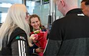 7 August 2023; The 2023 Irish World Para Swimming Championships Gold and Silver medalist Róisín Ní Riain is gifted flowers by members of Vision Sports Ireland Sara McFadden, left, Sean Moyles, and Sean Poland on her arrival at Dublin Airport on Team Ireland's return from the 2023 World Para Swimming Championships in Manchester. Photo by Tyler Miller/Sportsfile