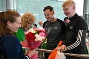 7 August 2023; The 2023 Irish World Para Swimming Championships Gold and Silver medalist Róisín Ní Riain is gifted flowers by members of Vision Sports Ireland Sean Poland, left, and Sean Moyles on her arrival at Dublin Airport on Team Ireland's return from the 2023 World Para Swimming Championships in Manchester. Photo by Tyler Miller/Sportsfile