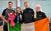 7 August 2023; The 2023 Irish World Para Swimming Championships Gold and Silver medalist Róisín Ní Riain is gifted flowers by members of Vision Sports Ireland Sean Poland, left, and Sean Moyles, second from right, and Sara McFadden, on her arrival at Dublin Airport on Team Ireland's return from the 2023 World Para Swimming Championships in Manchester. Photo by Tyler Miller/Sportsfile