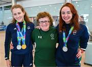 7 August 2023; The 2023 Irish World Para Swimming Championships swimmers Róisín Ní Riain, left, and Ellen Keane pose for a photograph with their medals and Ireland supporter Helen O'Leary at Dublin Airport on Team Ireland's return from the 2023 World Para Swimming Championships in Manchester. Photo by Tyler Miller/Sportsfile