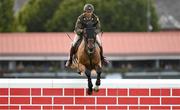 12 August 2023; Commandant Geoff Curran of Ireland competes on Bishops Quarter during the Defender Puissance during the 2023 Longines FEI Dublin Horse Show at the RDS in Dublin. Photo by David Fitzgerald/Sportsfile