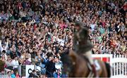 12 August 2023; Spectators celebrate after Commandant Geoff Curran of Ireland cleared 2 metres 20 on Bishops Quarter during the Defender Puissance during the 2023 Longines FEI Dublin Horse Show at the RDS in Dublin. Photo by David Fitzgerald/Sportsfile