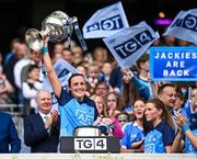 13 August 2023; Player of the match Hannah Tyrrell of Dublin lifts the Brendan Martin Cup as she celebrates with her daughter Aoife, age 7 weeks, after victory in the 2023 TG4 LGFA All-Ireland Senior Championship Final match between Dublin and Kerry at Croke Park in Dublin. Photo by Piaras Ó Mídheach/Sportsfile