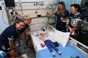 14 August 2023; Noah Quish, age 6, from Monaleen, Limerick with Dublin ladies players, from left, Orlagh Nolan, Carla Rowe, Grainne Fitzsimons and Leah Caffrey and the Brendan Martin Cup on a visit to CHI at Temple Street, Dublin. Photo by David Fitzgerald/Sportsfile