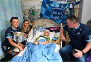 14 August 2023; Mia Healy Duggan, age 11, from Terenure, Dublin with Dublin ladies manager Mick Bohan and players Leah Caffrey, left, and Grainne Fitzsimons and the Brendan Martin Cup on a visit to CHI at Temple Street, Dublin. Photo by David Fitzgerald/Sportsfile