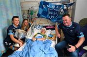 14 August 2023; Mia Healy Duggan, age 11, from Terenure, Dublin with Dublin ladies manager Mick Bohan and players Leah Caffrey, left, and Grainne Fitzsimons and the Brendan Martin Cup on a visit to CHI at Temple Street, Dublin. Photo by David Fitzgerald/Sportsfile