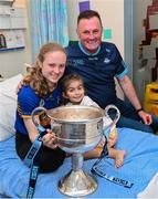 14 August 2023; Dublin ladies manager Mick Bohan with Katie Kelly, age 16, from Skeheenarinky, Tipperary, left, and Yaryna Bulharu, age 5, from Ukraine and the Brendan Martin Cup on a visit to CHI at Temple Street, Dublin. Photo by David Fitzgerald/Sportsfile
