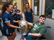 14 August 2023; Andre van Wyk, age 11, from Portmarnock, Dublin with Dublin ladies players, Leah Caffrey, left, and Grainne Fitzsimons and the Brendan Martin Cup on a visit to CHI at Temple Street, Dublin. Photo by David Fitzgerald/Sportsfile
