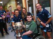 14 August 2023; Andre van Wyk, age 11, from Portmarnock, Dublin with Dublin ladies players, from left, Leah Caffrey, Carla Rowe, Grainne Fitzsimons and Orlagh Nolan and the Brendan Martin Cup on a visit to CHI at Temple Street, Dublin. Photo by David Fitzgerald/Sportsfile