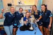 14 August 2023; Katie Kelly, age 16, from Skeheenarinky, Tipperary with Dublin ladies players, from left, Carla Rowe, Orlagh Nolan, Grainne Fitzsimons and Leah Caffrey and the Brendan Martin Cup on a visit to CHI at Temple Street, Dublin. Photo by David Fitzgerald/Sportsfile