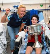 14 August 2023; Oisin Timoney, age 10, from Castleknock, Dublin with Dublin ladies captain Carla Rowe and the Brendan Martin Cup on a visit to CHI at Temple Street, Dublin. Photo by David Fitzgerald/Sportsfile