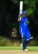 14 Augut 2023; Chris De Freitas of Leinster Lightning holds his bat aloft to acknowledge teammates after bring up his half century of runs during the Rario Inter-Provincial Cup match between Leinster Lightning and North West Warriors at The Hills Cricket Club in Dublin. Photo by Tyler Miller/Sportsfile