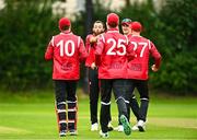 15 August 2023; Liam McCarthy of Munster Reds celebrates with team-mates after bowling out James McCollum of Northern Knights during the Rario Inter-Provincial Cup match between Munster Reds and Northern Knights at The Mardyke in Cork. Photo by Eóin Noonan/Sportsfile