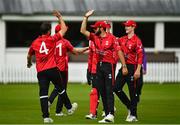 15 August 2023; Tyrone Kane of Munster Reds, left, celebrates with team-mates after bowling out Jake Egan of Northern Knights during the Rario Inter-Provincial Cup match between Munster Reds and Northern Knights at The Mardyke in Cork. Photo by Eóin Noonan/Sportsfile