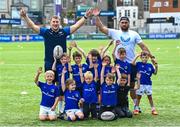 16 August 2023; Leinster players John McKee, left, and Charlie Ngatai with children during the Bank of Ireland Leinster rugby summer camp at Energia Park in Dublin. Photo by Piaras Ó Mídheach/Sportsfile