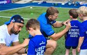 16 August 2023; Leinster players John McKee, right, and Charlie Ngatai sign autographs during the Bank of Ireland Leinster rugby summer camp at Energia Park in Dublin. Photo by Piaras Ó Mídheach/Sportsfile