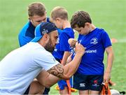 16 August 2023; Hugo Hastings has his jersey signed by Leinster player Charlie Ngatai during the Bank of Ireland Leinster rugby summer camp at Energia Park in Dublin. Photo by Piaras Ó Mídheach/Sportsfile