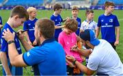 16 August 2023; Leinster players Charlie Ngatai, right, and John McKee sign autographs during the Bank of Ireland Leinster rugby summer camp at Energia Park in Dublin. Photo by Piaras Ó Mídheach/Sportsfile