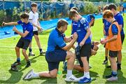 16 August 2023; Leinster players John McKee, front, and Charlie Ngatai sign autographs during the Bank of Ireland Leinster rugby summer camp at Energia Park in Dublin. Photo by Piaras Ó Mídheach/Sportsfile