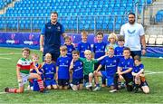 16 August 2023; Leinster players John McKee, left, and Charlie Ngatai with children during the Bank of Ireland Leinster rugby summer camp at Energia Park in Dublin. Photo by Piaras Ó Mídheach/Sportsfile