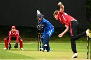 17 August 2023; Josh Manley of Munster Reds delivers to Seamus Lynch of Leinster Lightning during the Rario Inter-Provincial Cup match between Munster Reds and Leinster Lightning at The Mardyke in Cork. Photo by Eóin Noonan/Sportsfile