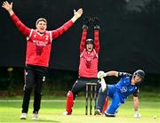 17 August 2023; PJ Moore, right, and Gareth Delaney of Munster Reds celebrate after taking the wicket of David Delaney of Leinster Lightning during the Rario Inter-Provincial Cup match between Munster Reds and Leinster Lightning at The Mardyke in Cork. Photo by Eóin Noonan/Sportsfile