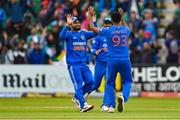 18 August 2023; Jasprit Bumrah of India, 93, celebrates with teammate Rinku Singh after taking the wicket of Ireland's Andrew Balbirnie during match one of the Men's T20 International series between Ireland and India at Malahide Cricket Ground in Dublin. Photo by Seb Daly/Sportsfile