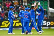 18 August 2023; Jasprit Bumrah of India, second from right, celebrates with wicketkeeper Sanju Samson after taking the wicket of Ireland's Andrew Balbirnie during match one of the Men's T20 International series between Ireland and India at Malahide Cricket Ground in Dublin. Photo by Seb Daly/Sportsfile