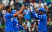 18 August 2023; India bowler Prasidh Krishna, left, is congratulated by teammate Sanju Samson after claiming the wicket of Ireland's Harry Tector during match one of the Men's T20 International series between Ireland and India at Malahide Cricket Ground in Dublin. Photo by Seb Daly/Sportsfile