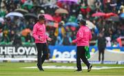 18 August 2023; Umpires Roland Black, left, and Mark Hawthorne in discussion before ordering the players off the field due to rain during match one of the Men's T20 International series between Ireland and India at Malahide Cricket Ground in Dublin. Photo by Seb Daly/Sportsfile