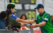 18 August 2023; Curtis Campher of Ireland signs autographs during match one of the Men's T20 International series between Ireland and India at Malahide Cricket Ground in Dublin. Photo by Seb Daly/Sportsfile