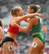 19 August 2023; Kate O’Connor of Ireland, right, and Sarah Lagger of Austria after their heat of the 100m hurdles of the Women's Heptathlon during day one of the World Athletics Championships at the National Athletics Centre in Budapest, Hungary. Photo by Sam Barnes/Sportsfile
