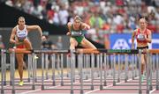 19 August 2023; Kate O’Connor of Ireland, centre, competes alongside Xénia Krizsan of Hungary, left, and Sarah Lagger of Austria in the 100m hurdles of the Women's Heptathlon during day one of the World Athletics Championships at the National Athletics Centre in Budapest, Hungary. Photo by Sam Barnes/Sportsfile
