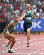 19 August 2023; Jack Raftery of Ireland, prepares to hand over the baton to teammate Sophie Becker in the mixed 4 x 400m relay during day one of the World Athletics Championships at the National Athletics Centre in Budapest, Hungary. Photo by Sam Barnes/Sportsfile