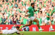 19 August 2023; Bundee Aki of Ireland evades the tackle of Ben Youngs of England on his way to scoring his side's first try during the Bank of Ireland Nations Series match between Ireland and England at Aviva Stadium in Dublin. Photo by Ramsey Cardy/Sportsfile
