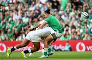 19 August 2023; James Lowe of Ireland is tackled by Manu Tuilagi of England during the Bank of Ireland Nations Series match between Ireland and England at Aviva Stadium in Dublin. Photo by Ramsey Cardy/Sportsfile