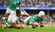 19 August 2023; Mack Hansen of Ireland dives over to score his side's fourth try despite the tackle of Joe Marchant of England during the Bank of Ireland Nations Series match between Ireland and England at the Aviva Stadium in Dublin. Photo by Harry Murphy/Sportsfile