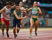 19 August 2023; Sophie Becker of Ireland passes the baton to Chris O’Donnell while competing in the mixed 4x400m relay final during day one of the World Athletics Championships at the National Athletics Centre in Budapest, Hungary. Photo by Sam Barnes/Sportsfile