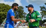20 August 2023; India captain Jasprit Bumrah, left, and Ireland captain Paul Stirling shake hands before match two of the Men's T20 International series between Ireland and India at Malahide Cricket Ground in Dublin. Photo by Seb Daly/Sportsfile