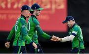 20 August 2023; George Dockrell of Ireland, left, is congratulated by teammate Curtis Campher, right, after catching out India's Tilak Varma during match two of the Men's T20 International series between Ireland and India at Malahide Cricket Ground in Dublin. Photo by Seb Daly/Sportsfile