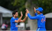 20 August 2023; India bowler Ravi Bishnoi, left, is congratulated by teammate Yashasvi Jaiswal after claiming the wicket of Ireland's Curtis Campher during match two of the Men's T20 International series between Ireland and India at Malahide Cricket Ground in Dublin. Photo by Seb Daly/Sportsfile