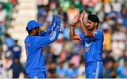 20 August 2023; India bowler Arshdeep Singh, right, and wicketkeeper Sanju Samson celebrate taking the wicket of Ireland's Andrew Balbirnie during match two of the Men's T20 International series between Ireland and India at Malahide Cricket Ground in Dublin. Photo by Seb Daly/Sportsfile